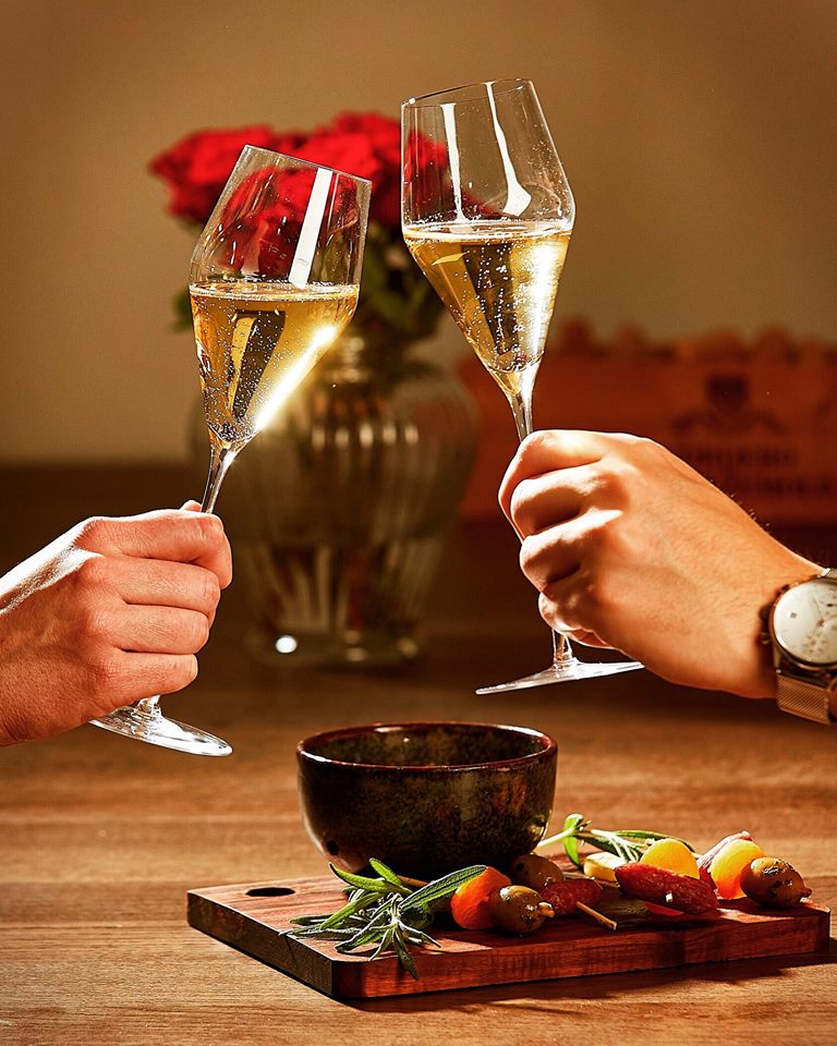 Two Zalto Champagne glasses in a toast